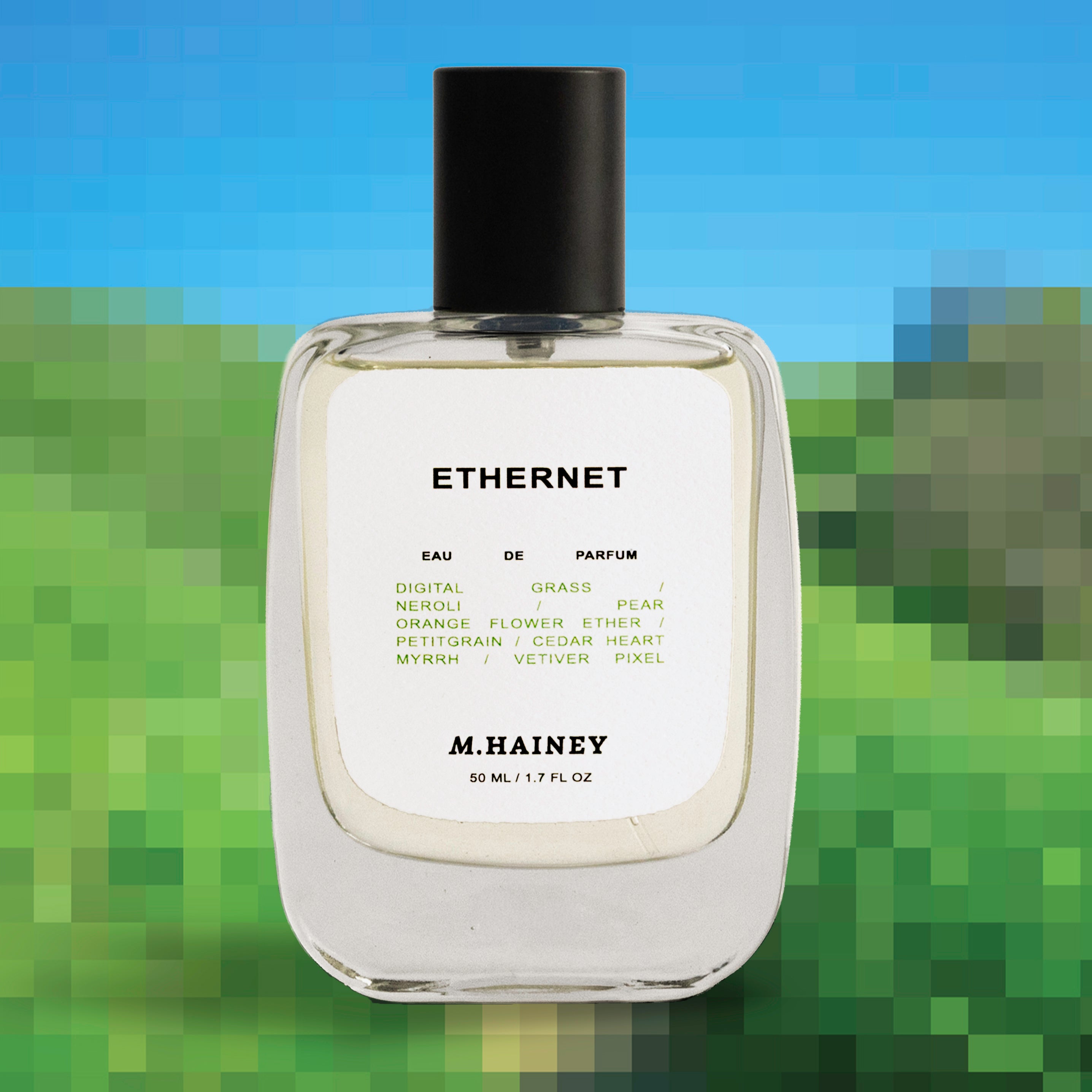 M.Hainey Ethernet perfume bottle with a blurred green and blue background