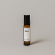 Bottle of Palo Santo perfume by M. Hainey on a gray background