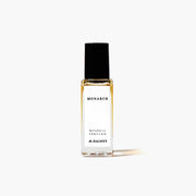 Perfume bottle labeled 'Monarch' by M. Hainey on a white background