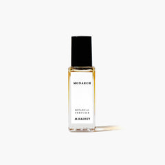 Perfume bottle labeled 'Monarch' by M. Hainey on a white background