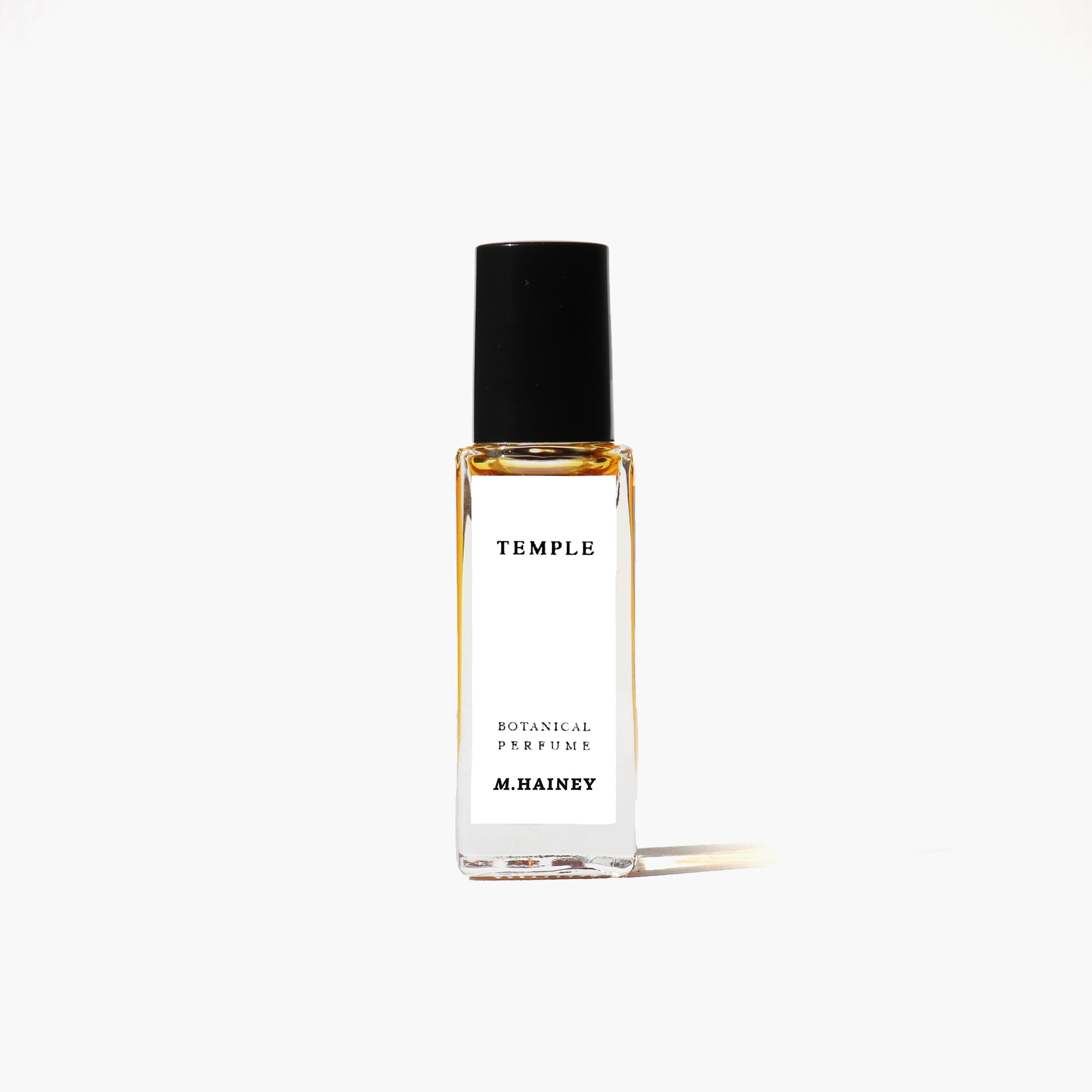 Perfume bottle labeled 'M.HAINEY' on a white background