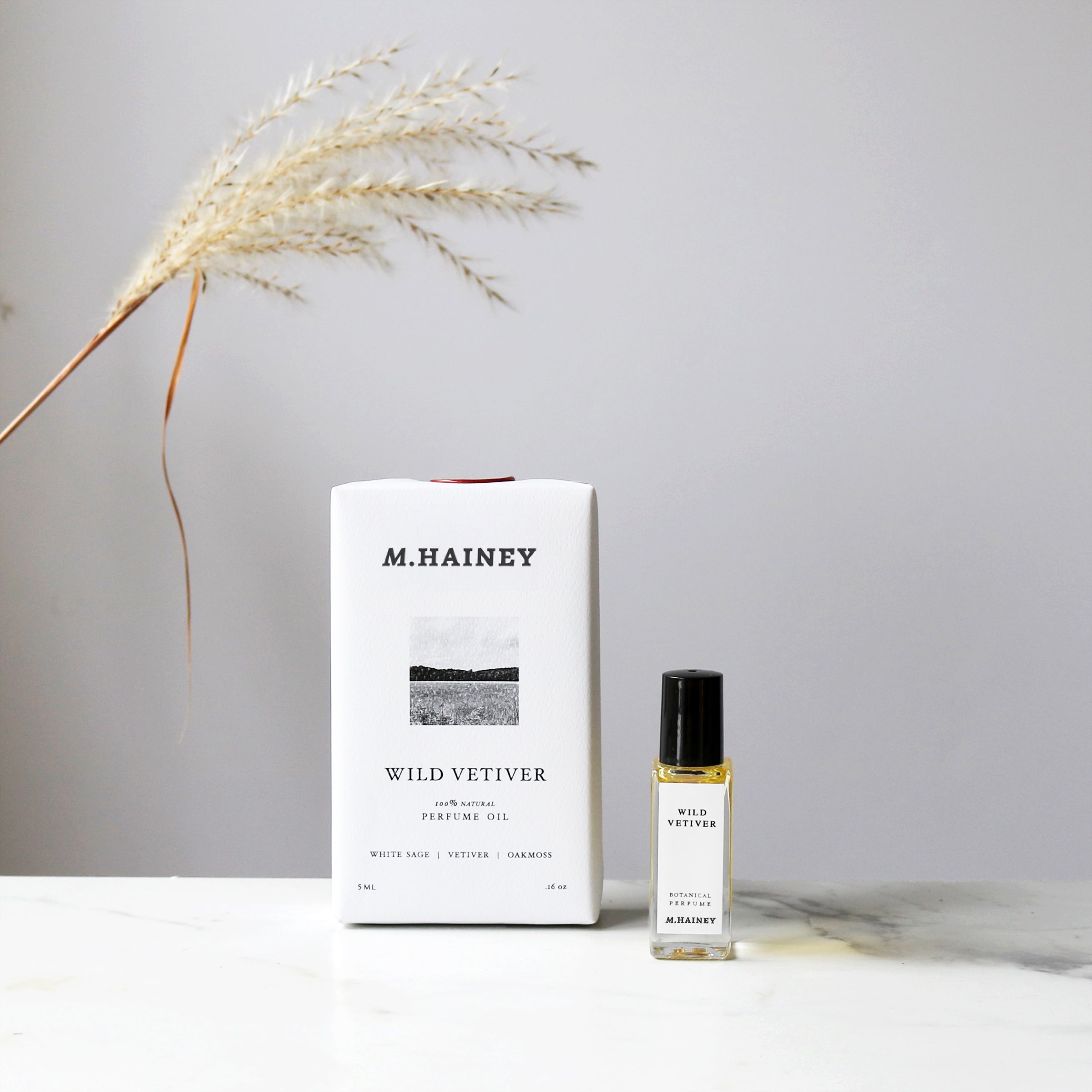 M. Hainey Wild Vetiver product packaging and bottle on a neutral background