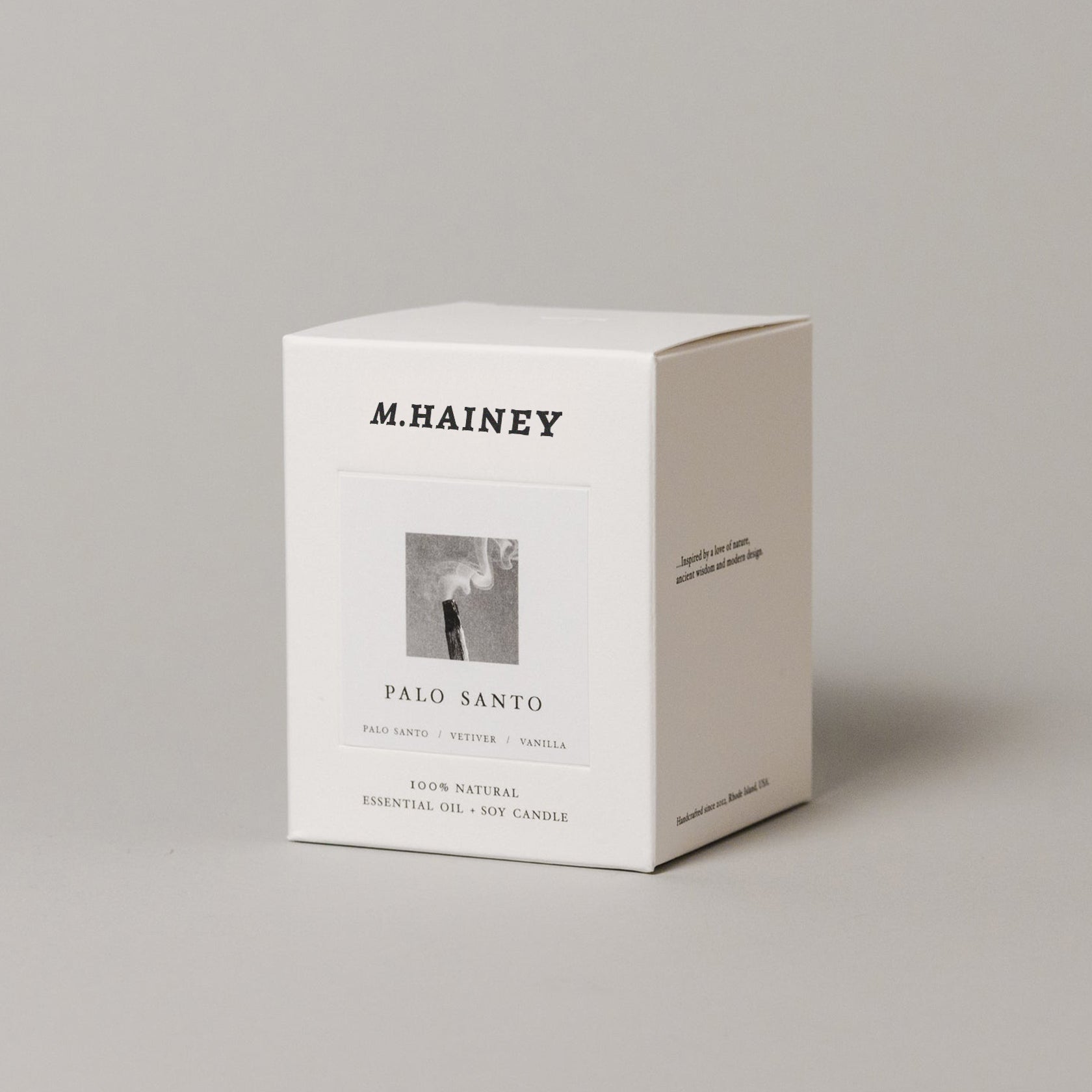 M.Hainey Palo Santo candle packaging on a gray background